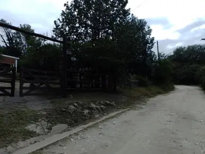 a fence on the side of a dirt road at La Nora in Cuesta Blanca