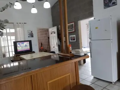 a kitchen with a white refrigerator and a television at La Nora in Cuesta Blanca