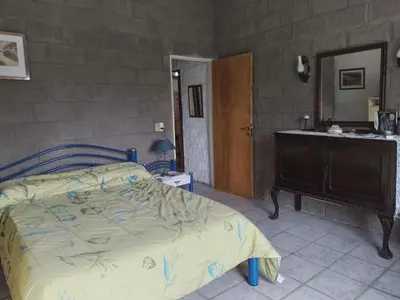 a bedroom with a bed and a sink and a mirror at La Nora in Cuesta Blanca