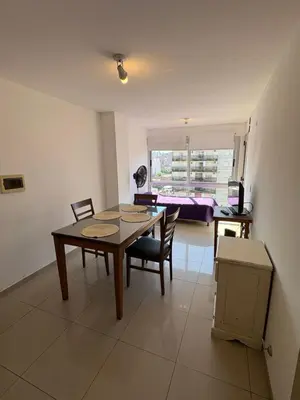 a dining room with a table and chairs in a room at Cañada 12 depto 1 dormitorio pax 3 in Cordoba
