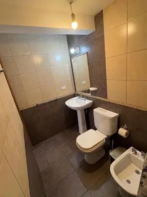 a bathroom with a toilet and a sink at Cañada 12 depto 1 dormitorio pax 3 in Cordoba