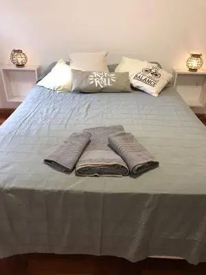 a bed with three towels on top of it at Chacabuco 3 Depto 1 dormitorio PAX 4 Nueva Cordoba in Cordoba