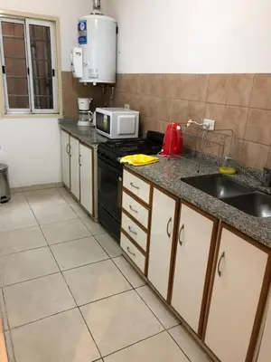 a kitchen with a sink and a stove top oven at Chacabuco 3 Depto 1 dormitorio PAX 4 Nueva Cordoba in Cordoba