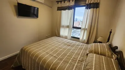 a bedroom with a bed and a window at Nazareno depto 1 dormitorio Guemes PAX 4 in Cordoba