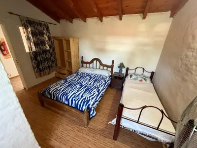 a bedroom with two beds in a room at Hosteria las Palmeras in Mina Clavero