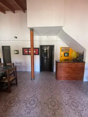 a room with a staircase and a room with a table at Hosteria las Palmeras in Mina Clavero