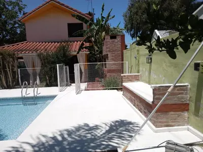 a house with a swimming pool in front of a house at Complejo La Tere- depto 2 in Cordoba