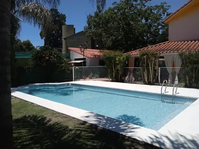 a swimming pool in front of a house at Complejo La Tere- depto 2 in Cordoba