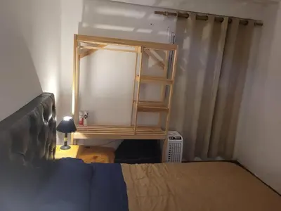 a bedroom with a book shelf next to a bed at Mate host in Cordoba