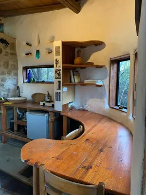 a kitchen with a wooden table in a room at El Jopi in Tanti