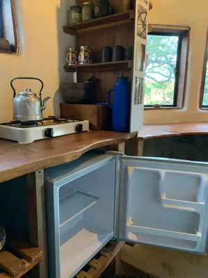 a kitchen with an open refrigerator and a stove at El Jopi in Tanti