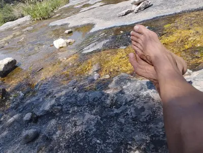 a man with his feet up on a rock at El Jopi in Tanti