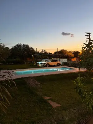 a car parked next to a swimming pool at SuiteMilSueños in Arroyo de Los Patos