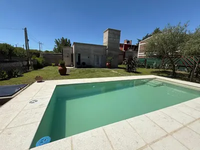 a swimming pool in the yard of a house at SuiteMilSueños in Arroyo de Los Patos