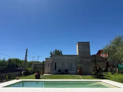 a house with a swimming pool in front of it at SuiteMilSueños in Arroyo de Los Patos