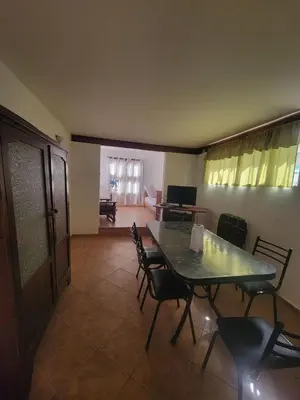a dining room with a green table and chairs at Alojamiento Esparta in Villa Carlos Paz
