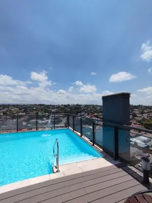 a swimming pool on the roof of a building at Excelente departamento moderno con pileta in Villa Carlos Paz