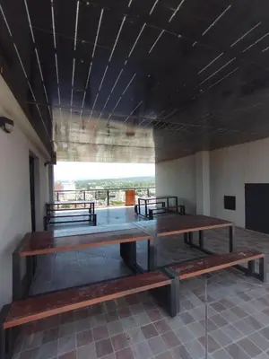 a group of benches sitting in a room at Excelente departamento moderno con pileta in Villa Carlos Paz