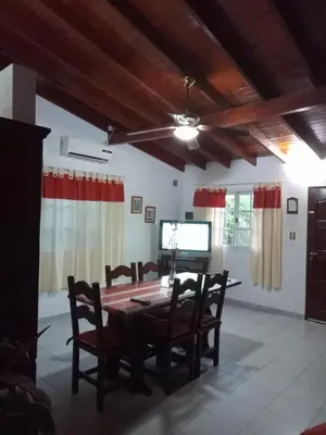 a dining room with a table and chairs and a tv at Valle de Bendición in El Rincón