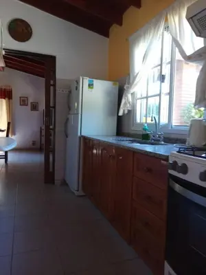 a kitchen with a white refrigerator and a window at Valle de Bendición in El Rincón