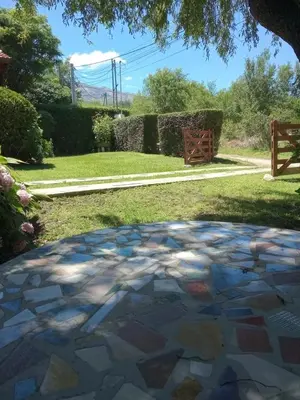 a stone patio in a yard with a tree at Valle de Bendición in El Rincón