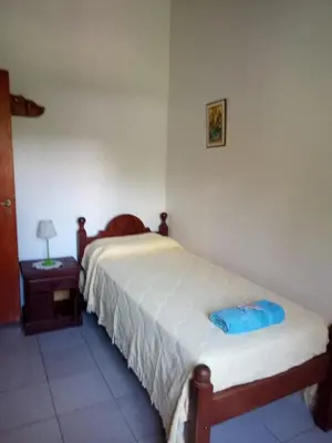 a bedroom with two beds and a table with a lamp at Valle de Bendición in El Rincón