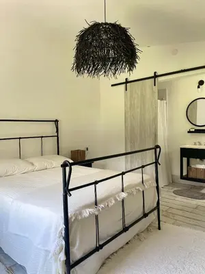 a bedroom with a bed and a hanging basket at Serena in Villa de Las Rosas