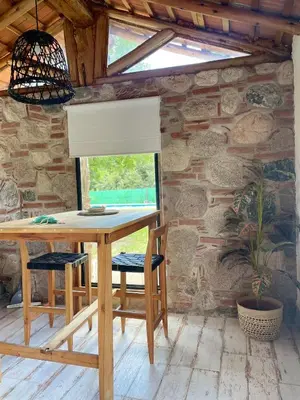 a wooden table with two chairs and a window at Serena in Villa de Las Rosas