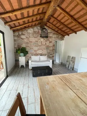 a living room with a couch and a stone wall at Serena in Villa de Las Rosas