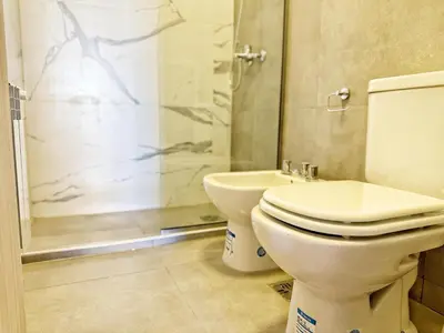 a bathroom with a toilet and a shower at Paseo Cibeles in Villa Carlos Paz