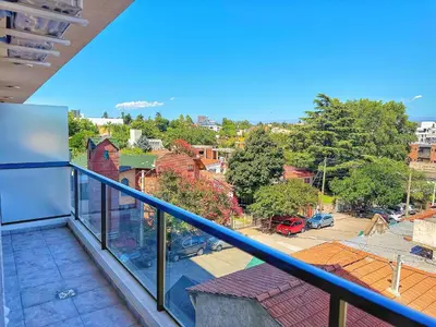a balcony with a view of a city at Paseo Cibeles in Villa Carlos Paz