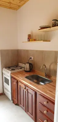 a kitchen with a sink and a stove at Complejo Canto de los Pájaros in Villa Parque Siquiman