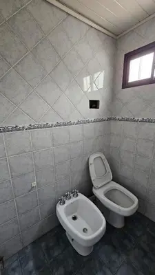 a bathroom with a toilet and a bidet at Perla de Punilla in Villa Carlos Paz
