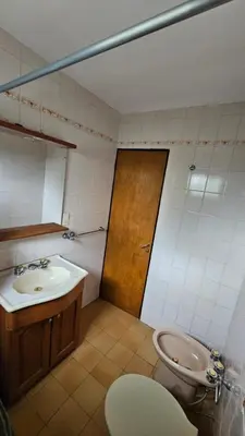 a bathroom with a sink and a toilet at Perla de Punilla in Villa Carlos Paz