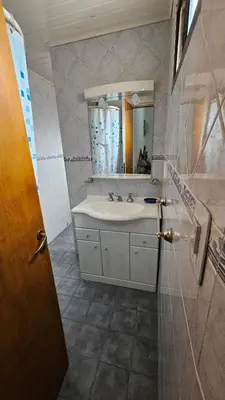 a bathroom with a sink and a mirror at Perla de Punilla in Villa Carlos Paz