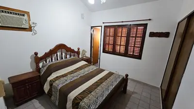 a bedroom with a bed and a window at Perla de Punilla in Villa Carlos Paz