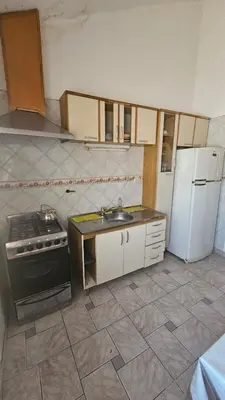a kitchen with a stove and a sink and a refrigerator at Perla de Punilla in Villa Carlos Paz