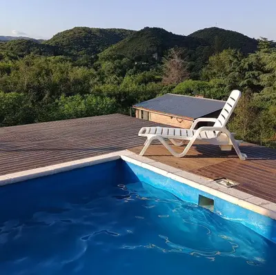 a chair sitting on a deck next to a swimming pool at La Calandria in Villa Serranita