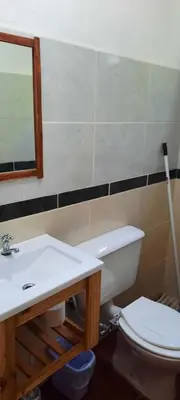 a bathroom with a toilet and a sink and a mirror at Las Tacuaras in Arroyo de Los Patos