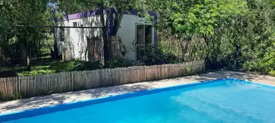 a swimming pool in front of a fence at Las Tacuaras in Arroyo de Los Patos