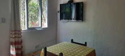 a room with a table and a tv on a wall at Las Tacuaras in Arroyo de Los Patos