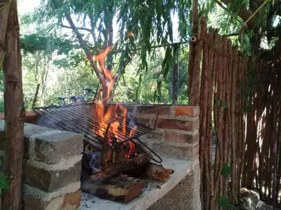 a fire pit in a yard next to a fence at Las Tacuaras in Arroyo de Los Patos