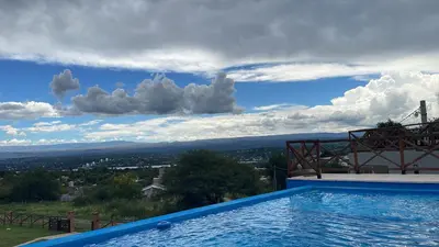 a swimming pool with a view of a city at Cabaña La Reserva in San Roque