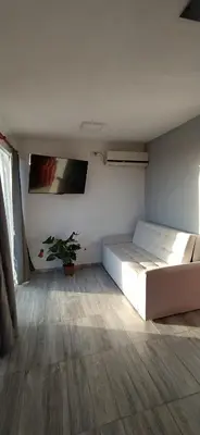 a bedroom with a bed and a tv on the wall at Cabaña La Reserva in San Roque