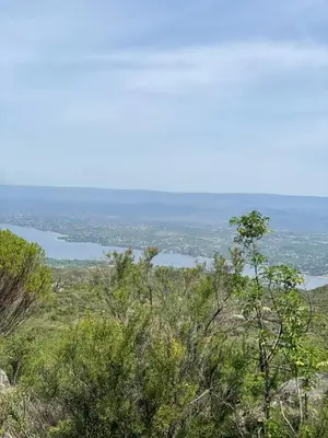 a view of a lake from the top of a hill at Cabaña La Reserva in San Roque