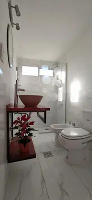 a white bathroom with a toilet and a sink at Cabaña La Reserva in San Roque