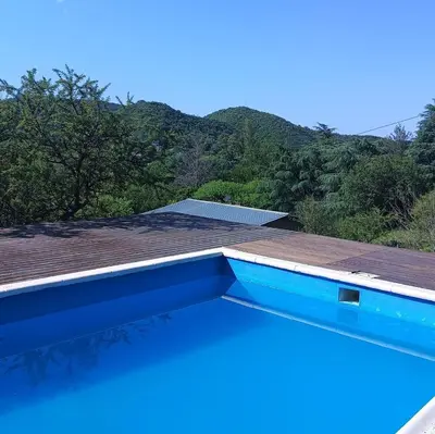 a swimming pool on the roof of a house at La Calandria in Villa Serranita