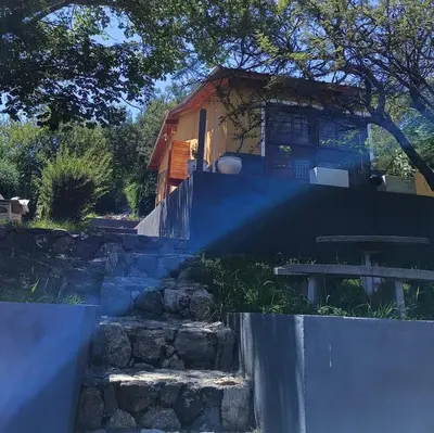 a house with a fence and stairs in front of it at La Calandria in Villa Serranita