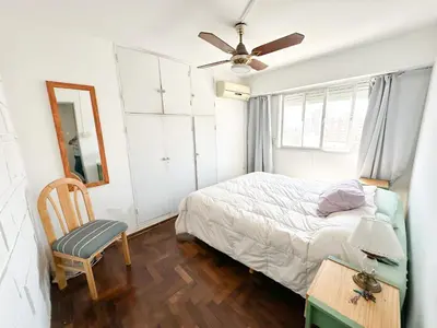 a bedroom with a bed and a ceiling fan at departamento temporal 3 personas in Cordoba