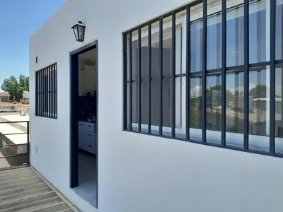 an open door to a building with windows at Fabiana Torres in Villa Carlos Paz